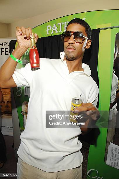 Farnsworth Bentley holds a bottle of Piper Heidsieck champagne at the Star Lounge In Honor of Rolling Stone's 40th Anniversary at the Hard Rock Hotel...