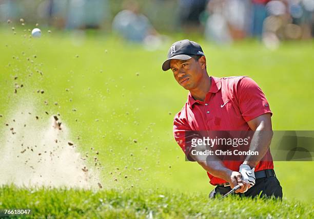 Tiger Woods hits from a bunker on the second hole during the final round of BMW Championship, the third event of the new PGA TOUR Playoffs for the...