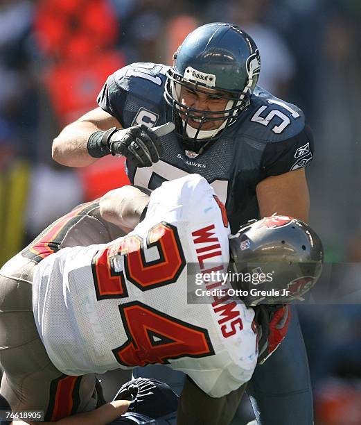Running back Carnell Williams of the Tampa Bay Buccaneers is tackled by Lofa Tatupu of the Seattle Seahawks at Qwest Field on September 9, 2007 in...
