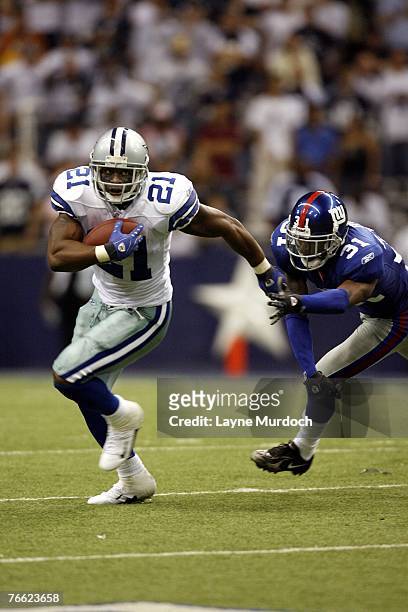 Julius Jones of the Dallas Cowboys runs the ball against Aaron Ross of the New York Giants at Texas Stadium September 9, 2007 in Irving, Texas.