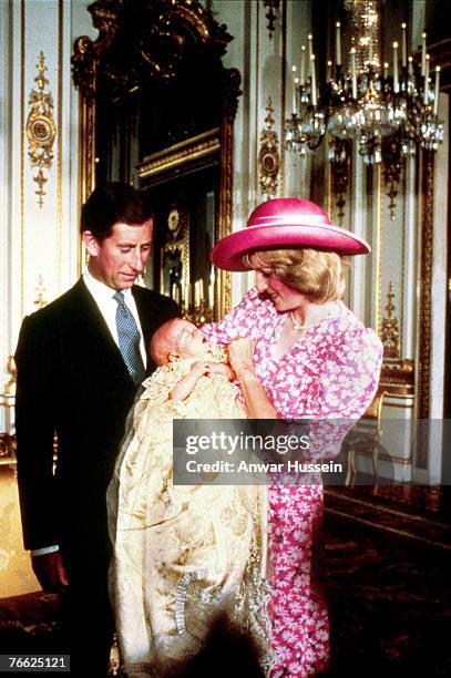 Diana and Prince Charles look on lovingly at baby Prince William on the day of his Christening at Buckingham Palace in 1982.