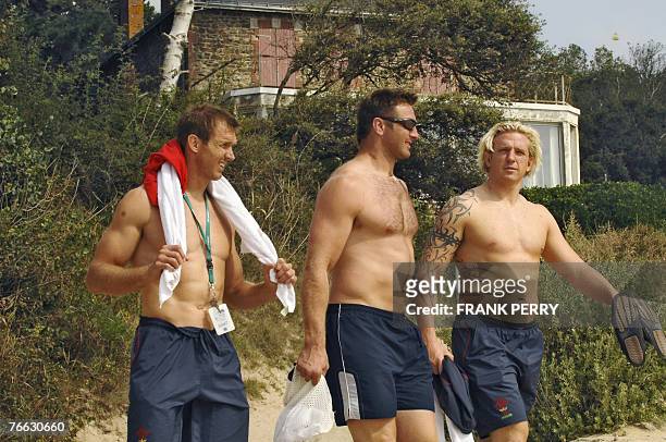 Wales rugby union national team players Kevin Morgan and Alix Popham walk toward the beach to enjoy their day off, one day after defeating Canada in...