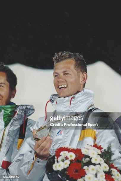 French freestyle skier Edgar Grospiron of the France team pictured holding his gold medal after finishing in first place to win the Men's mogels...
