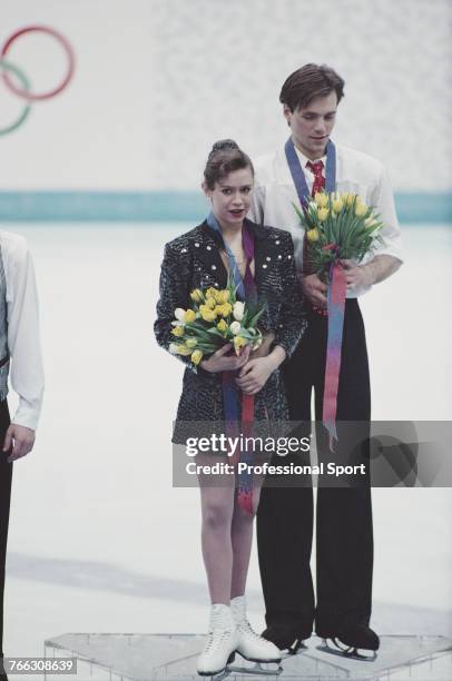 Russian ice dancers Oksana Grishuk and Evgeni Platov of the Russia team pictured together on the medal podium after finishing in first place to win...