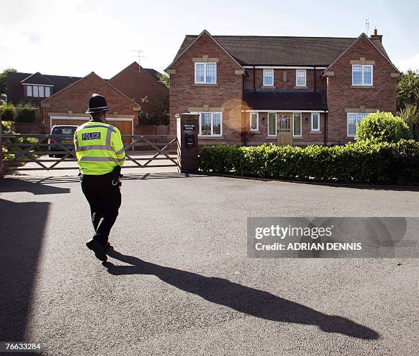 Police officer stands outside the McCann's house at the family home in Rothley, Leicestershire, in central England, 10 September 2007. The parents of...