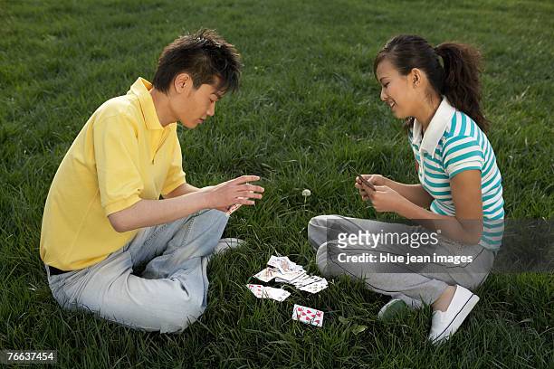 two people are playing cards. - thinking of you card stock-fotos und bilder