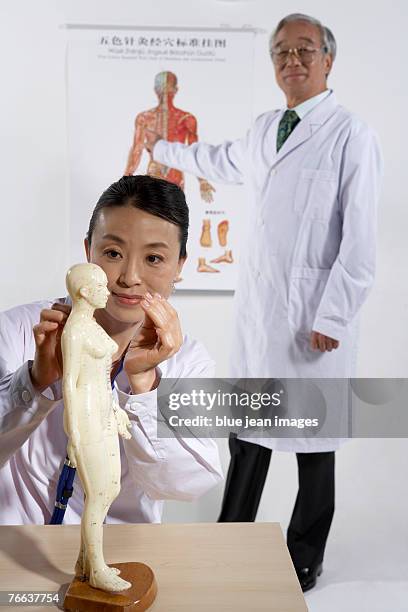 two doctors are examining. - acupuncture elderly stock pictures, royalty-free photos & images