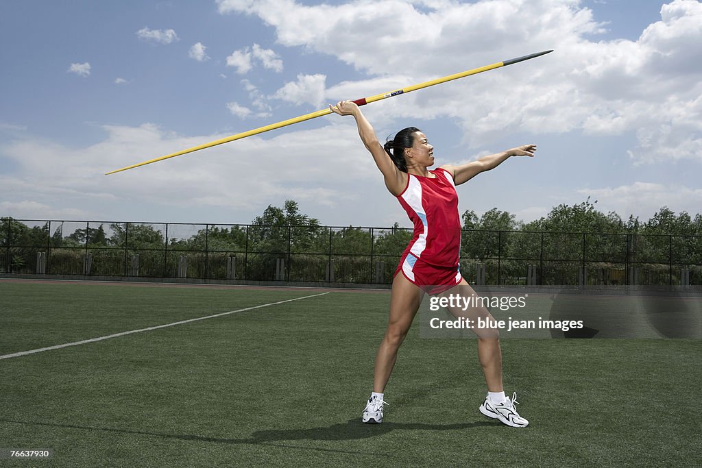A track and field athlete is throwing the javelin.