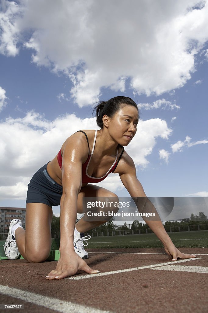 A track and field athlete prepares to run.