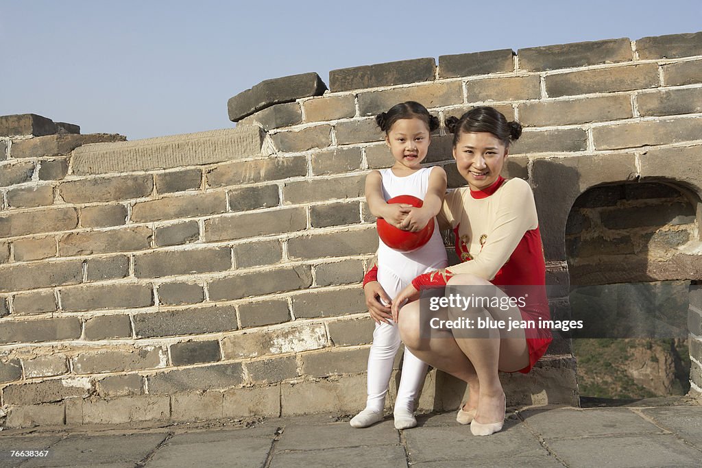 A young woman and a girl standing on the Great Wall of China.