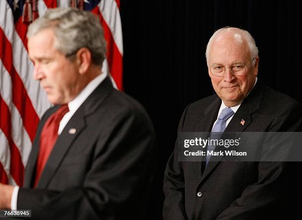 Vice President Dick Cheney listens as U.S. President George W. Bush speaks during a swearing-in ceremony for Jim Nussle as Director of the Office of...