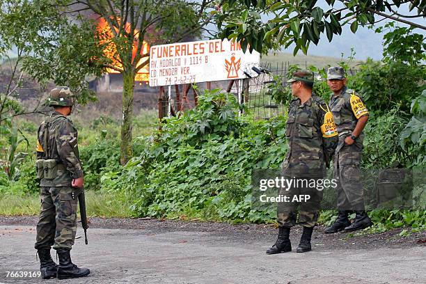 Mexican military personnel stand guard close to a natural gas pipeline that was damaged early Monday when according to state-owned oil company Pemex...