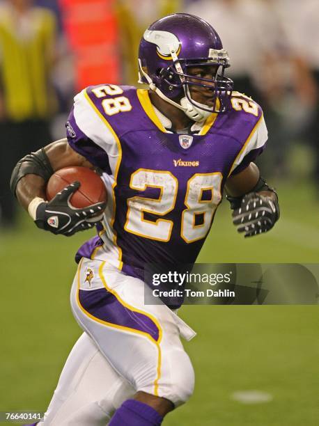 Adrian Peterson of the Minnesota Vikings carries the ball during an NFL game against the Atlanta Falcons at the Hubert H. Humphrey Metrodome,...