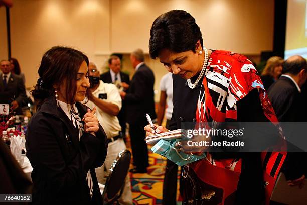 PepsiCo's chair and CEO, Indra Nooyi signs an autograph for Almas Khan as she visits the Miami Dade College Miami Leadership Roundtable September 10,...