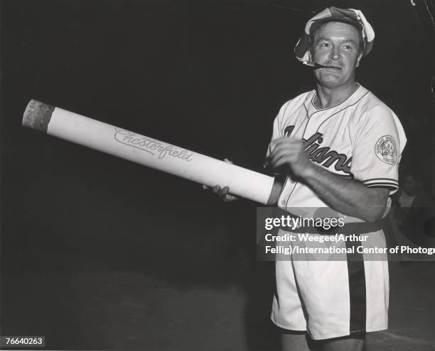 Portrait of British-born American comedian and radio & television personality Bob Hope , dressed in a Cleveland Indians baseball jersey, boxing...