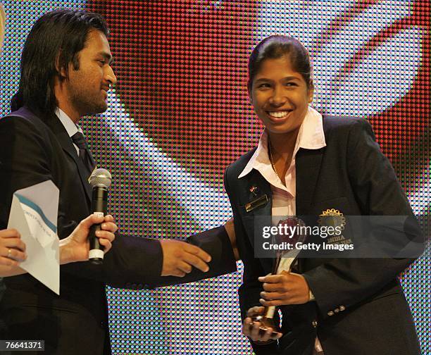 Women's Cricketer of the Year, Jhulan Goswami, receives the trophy from Mahendra Singh Dhoni at the ICC Awards prior to the ICC Twnety 20...