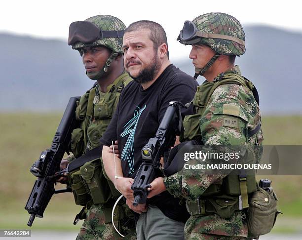 Drug lord Diego Leon Montoya Sanchez a.k.a. Don Diego is escorted by Colombian soldiers in Bogota after being flown from where he was captured, 10...