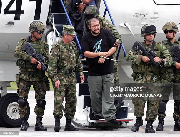 Drug lord Diego Leon Montoya Sanchez a.k.a. Don Diego is escorted by Colombian soldiers in Bogota after being flown from where he was captured, 10...