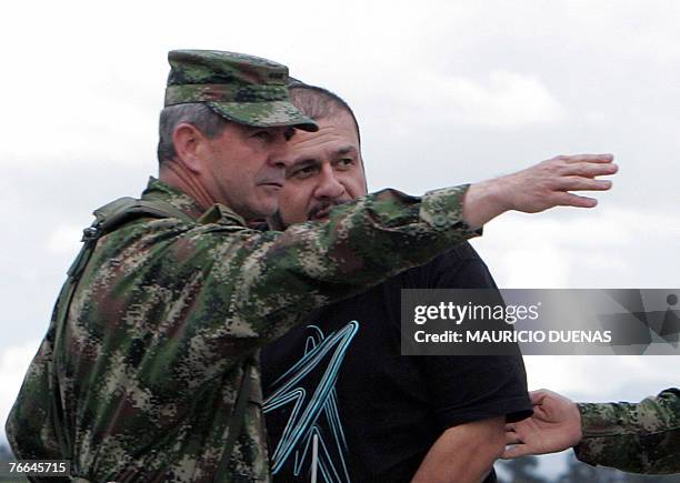 Commander of the Colombian Army General Mario Montoya shows the way to Drug Lord Diego Montoya Sanchez a.k.a. Don Diego after being flown from where...