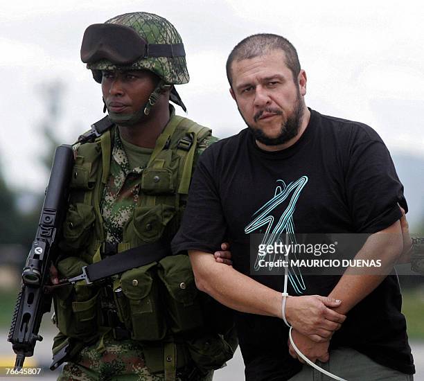 Drug lord Diego Leon Montoya Sanchez , a.k.a. Don Diego, is escorted by Colombian soldiers in Bogota after being flown from where he was captured, 10...