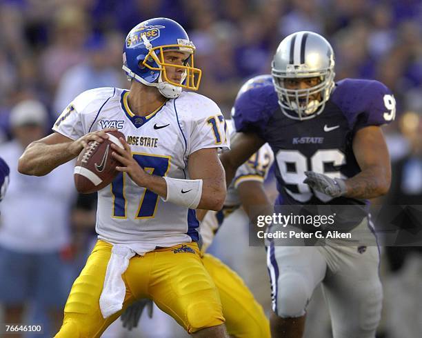 Quarterback Adam Tafralis of the San Jose State Spartans looks to pass against defender Moses Manu of the Kansas State Wildcats during a NCAA...