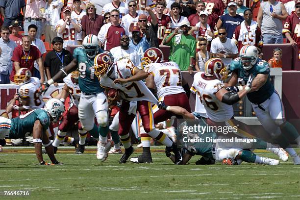 Linebacker Zach Thomas of the Miami Dolphins tries to tackle quarterback Jason Campbell of the Washington Redskins during a game on September 9, 2007...