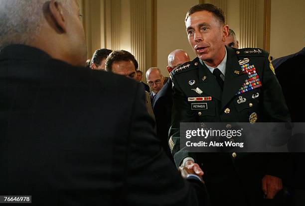 General David Petraeus shakes hands with members of Congress as he leaves a joint hearing of the House Armed Services Committee and the House Foreign...