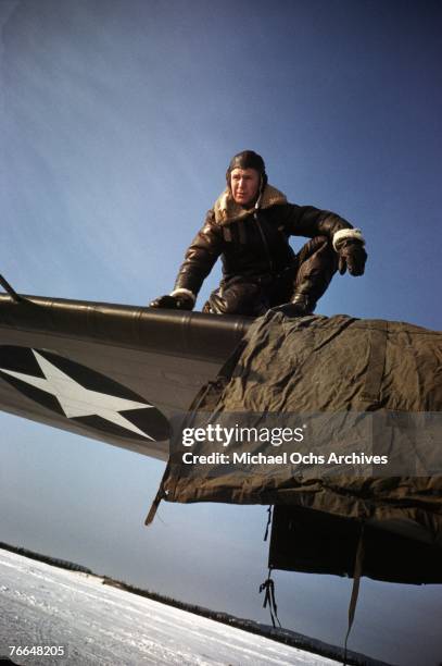 Crew member removes a protective tarpaulin before a mission at a United States Army Air Force base in December 1942 in Goose Bay, Labrador, Canada.