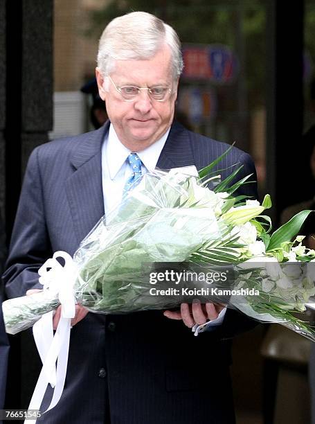 Ambassador to Japan Thomas Schieffer pays his respects and present flowers at the the 9/11 memorial in front of the headquarters of the Mizuho...