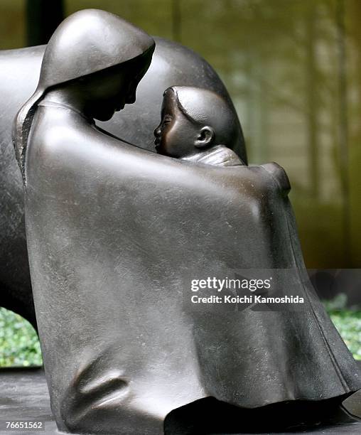 The statue of the 9/11 memorial is seen in front of the headquarters of the Mizuho Financial Group in Otemachi on September 11, 2007 in Tokyo, Japan....