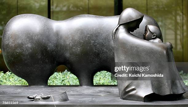 The statue of the 9/11 memorial is seen in front of the headquarters of the Mizuho Financial Group in Otemachi on September 11, 2007 in Tokyo, Japan....