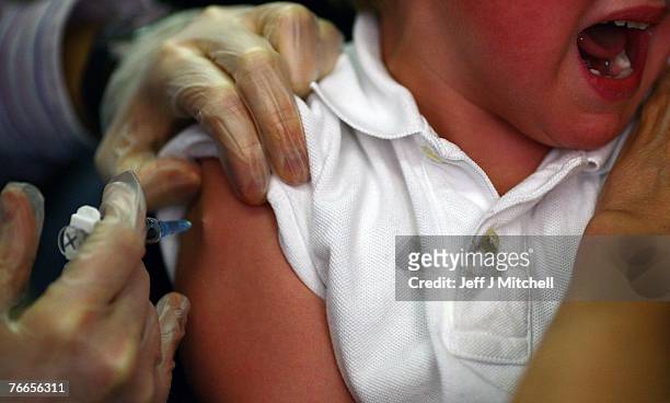 Young boy receives a immunization jab at a health centre on September 11, 2007 in Glasgow, Scotland. Medical experts still believe the MMR jab is...