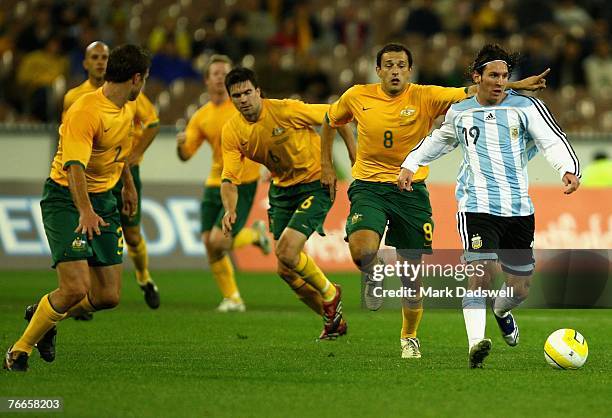 Lionel Messi of Argentina leads the Socceroos defence during the international friendly match between the Australian Socceroos and Argentina at the...