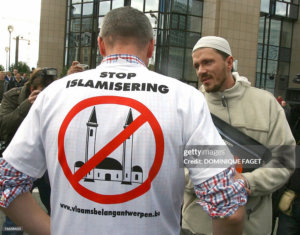 A muslim man talks with a demonstrator 1