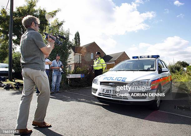 Television video journalist films the front of a police car at the entrance to the private road of the McCann family home in the village of Rothley,...