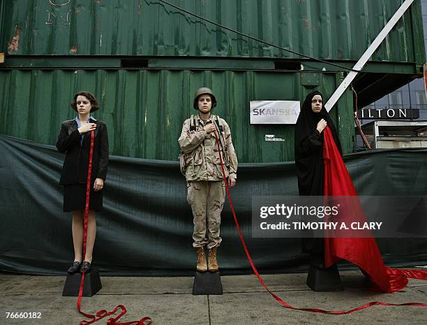 Performance artist Sara, Kelly and Alicia Casilio from the group known as Triiibe protest against the war in front of ground zero at the World Trade...