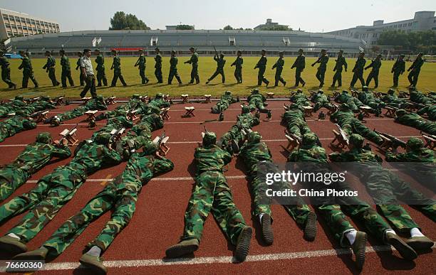 Freshmen from the Nanjing University of Science and Technology practice shooting skills during a military training session on September 11, 2007 in...