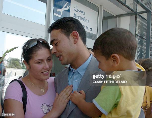 Tunisian fisherman Hamza Brahim hugs his wife and son upon his arrival 11 September 2008 at the Tunis-Carthage airport after being released by the...