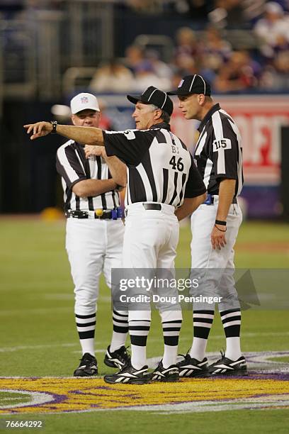 Referee John Parry, Back Judge Perry Paganelli and Umpire Tony Michalek work the field as the Minnesota Vikings defeated the Atlanta Falcons 24-3 at...