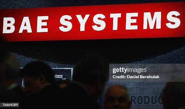 People congregate at the BAE Systems stand during the Defence Systems and Equpment International at the Excel Centre on September 11, 2007 in London,...