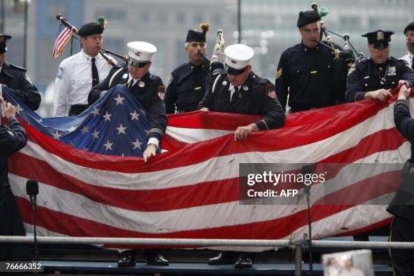 Firefighters and police officers carry t Firefighters and police officers carry t
