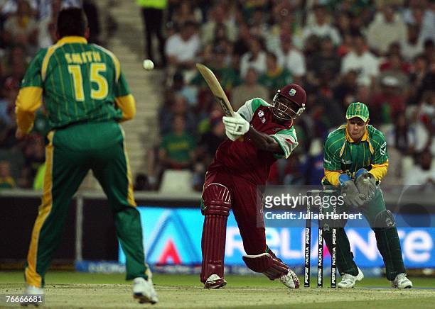 Chris Gayle of West Indies is watched by Mark Boucher of South Africa as he scores of the bowling of Graeme Smith, at The Wanderers Cricket Ground...