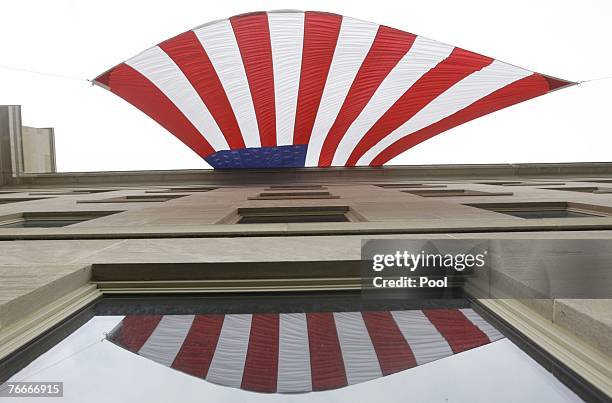 Flag hanging on the side of the Pentagon that was hit on 9/11, blows in the wind before the start of the wreath laying ceremony and observance at the...