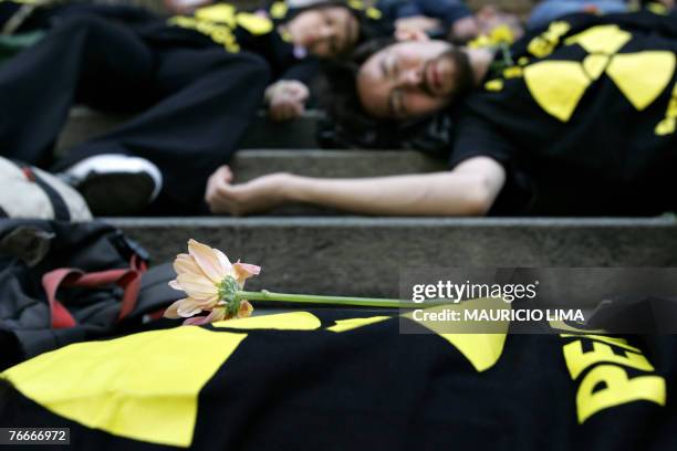 Greenpeace activists lie at the stairs of the Municipal Theatre representing the victims of a Cesium-137 radioactive accident that 20 years ago...