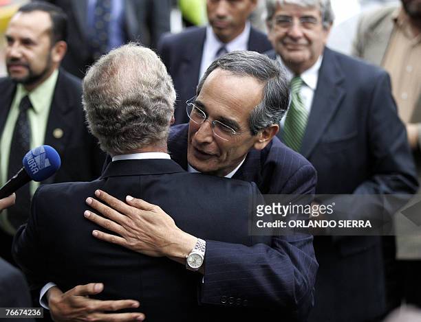 Presidential candidate for the Unidad Nacional de la Esperanza party, Alvaro Colom , embraces Guatemala City Mayor elect Alvaro Arzu of the Partido...