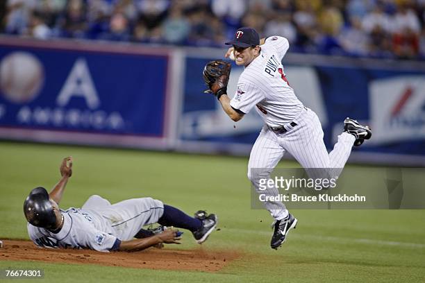 Nick Punto of the Minnesota Twins cannot turn a double play as Jose Guillen of the Seattle Mariners breaks up the attempt at the Humphrey Metrodome...