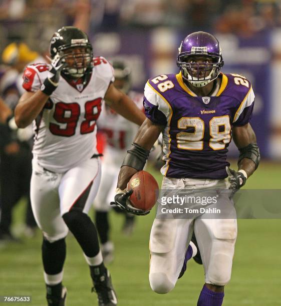 Adrian Peterson of the Minnesota Vikings runs for a fourth quarter touchdown during an NFL game against the Atlanta Falcons at the Hubert H. Humphrey...