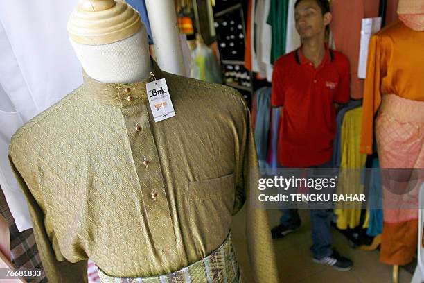 Traditional "Baju Melayu" costume, customarily worn for Eid al-Fitr at the end of Ramadan by ethnic Muslim Malays, goes on early display at a tailor...