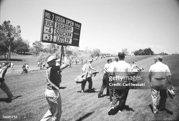 Golfers and several other people walk along the course at the United States Open Championship at Cherry Hills Country Club, Cherry Hills Village ,...
