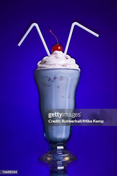 milkshake with two straws and maraschino cherry - maraschino stock pictures, royalty-free photos & images